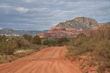 Red dirt road leading to a historic cliff dwelling site called Honanki