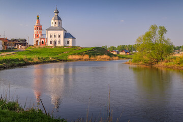 Fototapeta na wymiar Orthodox church at golden sunrise with river, Suzdal, Russia