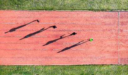 runners reaching the finish line in race on athletics track