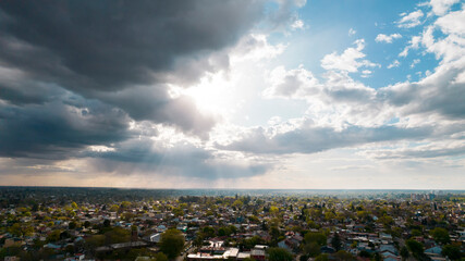 aerial view of glorious sky with clouds and sun rays illuminating the city