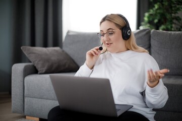 Woman using headset and laptop