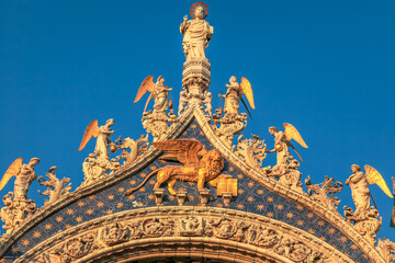 Fototapeta na wymiar St Mark Basilica facade detail, with lion and angels, Venice, Italy