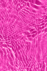 Defocus blurred transparent purple colored clear calm water surface texture with splashes and bubbles. Trendy abstract nature background. Water waves in sunlight with copy space. Watercolor shine