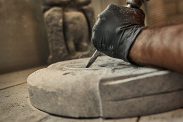 The craftsman works with stone with different tools. atmospheric photo. Sculpture making, handmade