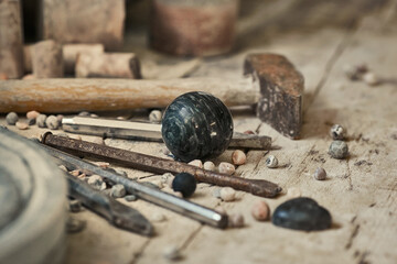 background with various tools for working with stone. Stone sculptures in the background in the workshop. hand made © svitlychnaja