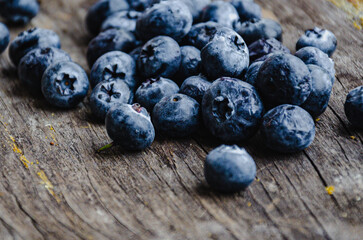 Blueberries on a wooden board in the garden.