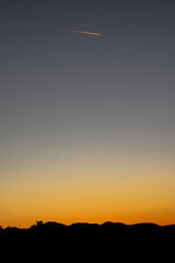 airplane flying over the sunset