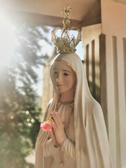 Mother Mary statue praying with her hands joined ,with a crown. Our Lady of Fatima. Paray-le-Monial, France.
