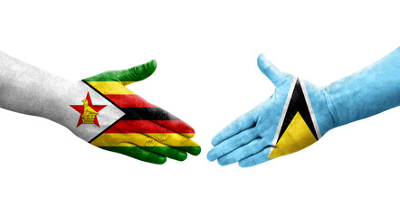 Handshake between Saint Lucia and Zimbabwe flags painted on hands, isolated transparent image.