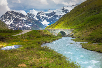 Col de l'Iseran snowcapped landscape and lake reflection in Vanoise, France
