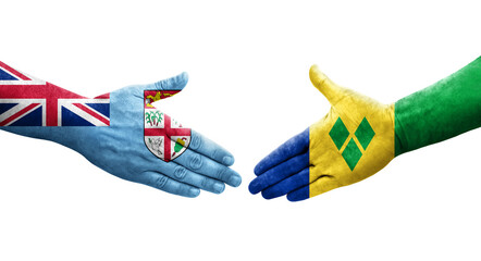 Handshake between Saint Vincent Grenadines and Fiji flags painted on hands, isolated transparent image.