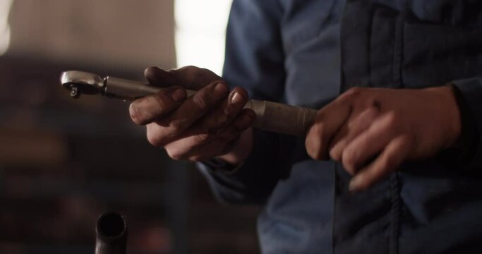 Male technician adjusting torque wrench