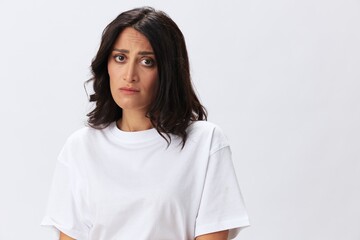 Woman headache and sadness, stress and depression, woman in a white t-shirt on a white background illness, copy space