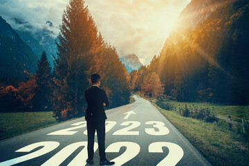 The 2023 New Year journey and future vision concept . Businessman traveling on highway road leading...