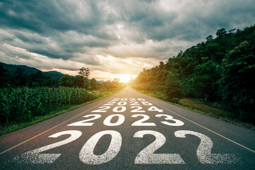New year 2023, 2024, 2025, 2026 or straight forward concept. Text 2023 written on the road in the middle of asphalt road with at sunset. Concept of planning, goal, challenge, new year resolution..