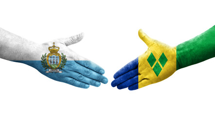 Handshake between Saint Vincent Grenadines and San Marino flags painted on hands, isolated transparent image.