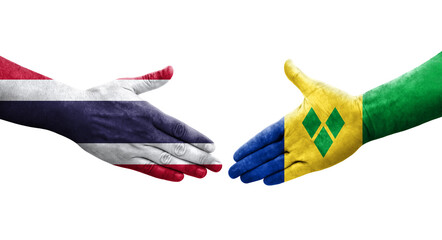 Handshake between Saint Vincent Grenadines and Thailand flags painted on hands, isolated transparent image.