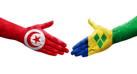 Handshake between Saint Vincent Grenadines and Tunisia flags painted on hands, isolated transparent image.