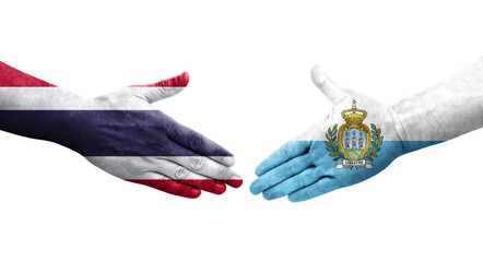 Handshake between San Marino and Thailand flags painted on hands, isolated transparent image.
