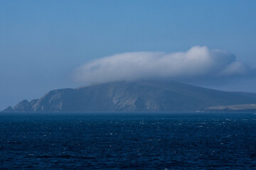 Cliffs and rocky coastline silhouette coast of Shetland Islands in Atlantic Ocean on sunny day with...