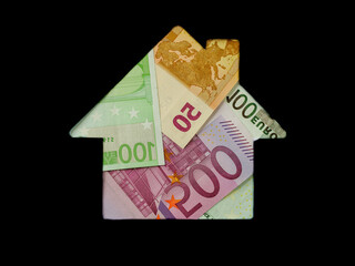 Euro banknote in shape of house on white background. Concept of Investment property, Mortgage concept. Investment risk and uncertainty in real estate housing market, utility bills. Top view flat lay