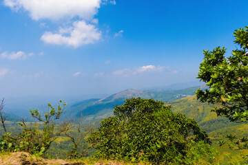 Beautiful hills of Chikmagalur,with fluffy clouds rolling over the blue sky.