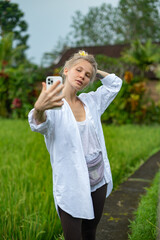 Girl make a selfie outdoor in green rice terrace
