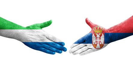 Handshake between Serbia and Sierra Leone flags painted on hands, isolated transparent image.