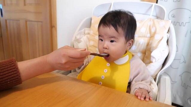 Japanese infant eating baby food