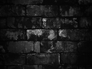 Old weathered dark bricks wall for abstract brick background and texture.