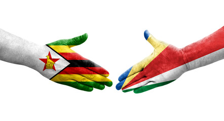 Handshake between Seychelles and Zimbabwe flags painted on hands, isolated transparent image.