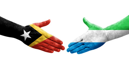 Handshake between Sierra Leone and Timor Leste flags painted on hands, isolated transparent image.