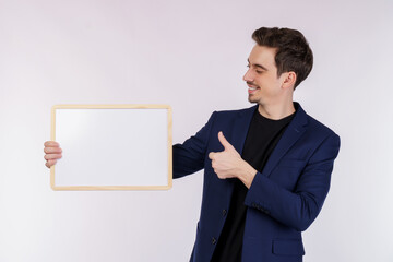 Portrait of happy businessman showing blank signboard on isolated white background