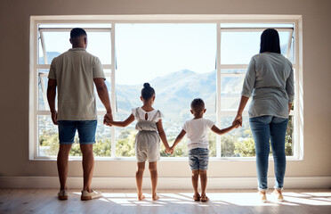 Love, back view and family holding hands by window looking at scenic view of nature, trees and mountain. Bonding, affection and mom and dad standing with kids in new apartment, happy in family home