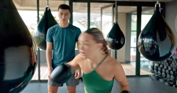 Fitness, boxing and woman training with coach in gym for health, wellness and cardio. Sports, exercise and personal trainer giving motivation and encouragement to female athlete in kickboxing studio