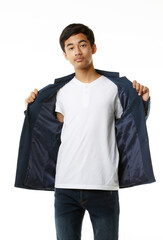 Smart, slim, tall Asian teenage boy in casual clothes standing elegantly on white background, open jacket to show inside the t-shirt. - 545334603
