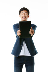 Asian male junior high school student 15 years old holding and showing blank screen of tablet computer. Modern teen life concept and technology. - 545335047