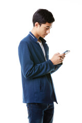 A 15-year-old Asian junior high school student holding and typing chat message on mobile phone screen to keep in touch with social world over Internet. - 545335445
