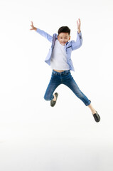 A 10-year-old Asian boy in a casual jacket is jumping smartly and happily looking at the camera against a white isolate background. - 545335658