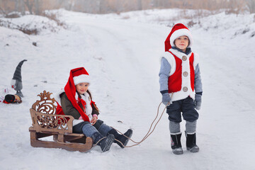a boy and a girl are taking gifts to Santa Claus on a sleigh. new Year's miracle for children