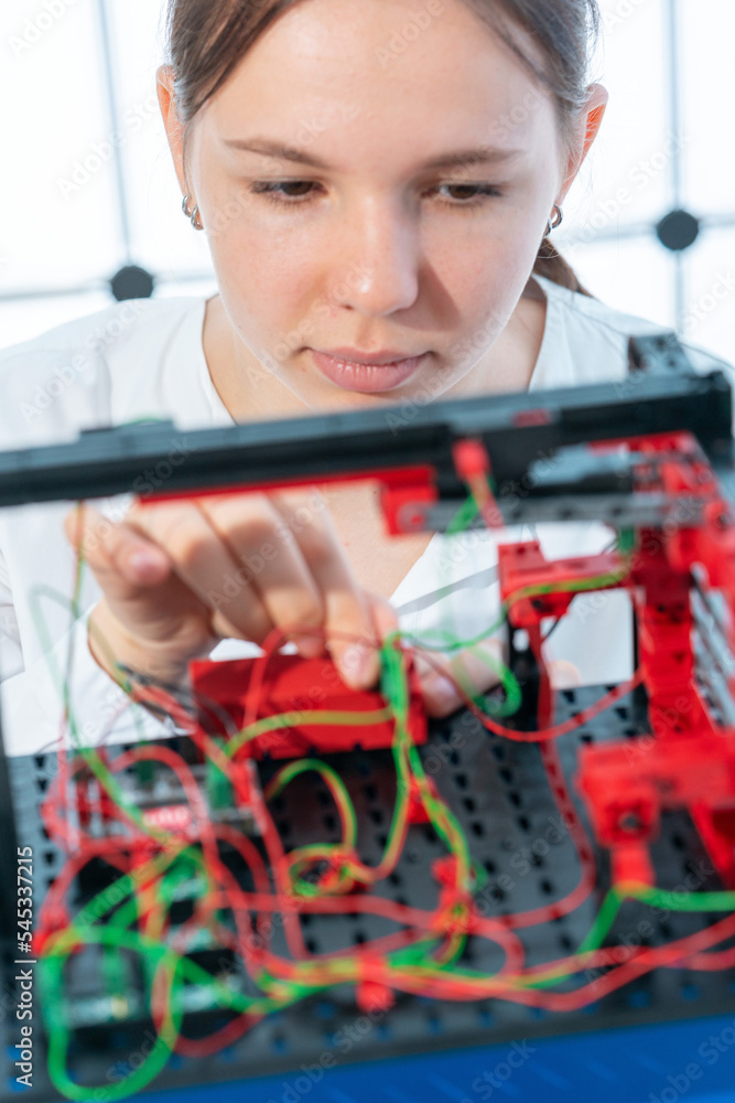 Wall mural girl student in the electronics class designs a computer-controlled device