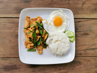 Pad prik gaeng moo or stir fried red curry pork with white rice. Thai street food in Thailand.