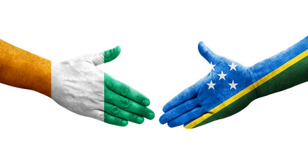 Handshake between Solomon Islands and Ivory Coast flags painted on hands, isolated transparent image.