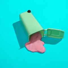 Creative minimalist layout. Trash can with slime on a blue background. Surreal summer idea. Conceptual pop
