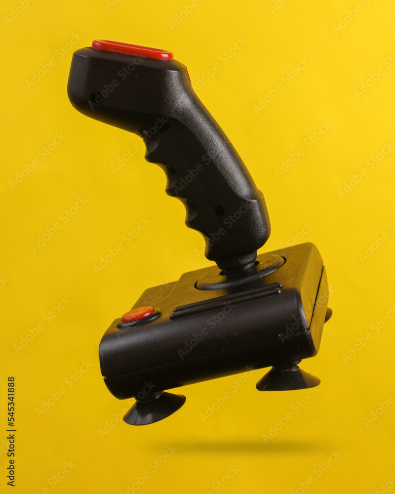 Poster retro joystick levitating on a yellow background with a shadow