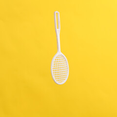 Toy tennis racket isolated on yellow background