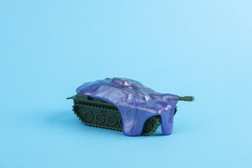 Military tank with slime on blue background. Minimalism creative layout