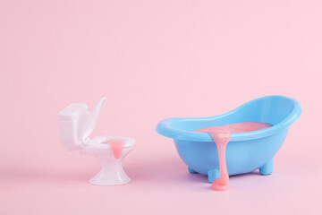 Toilet and bathroom with slime on a pink background. Minimal creative layout