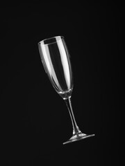 Empty champagne glass isolated on black background