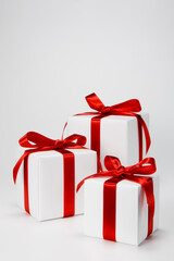 Gift boxes decorated with red ribbons. 
